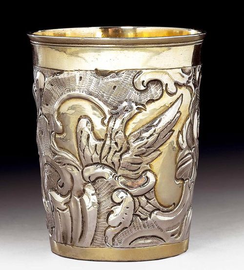 BEAKER. Parcel-gilt. Russia, ca. 1750.With maker's mark and inspector's mark. Embossed and chased on all sides with rocaille, scrolls and eagles. Cylindrical. H 8 cm. 60 g.