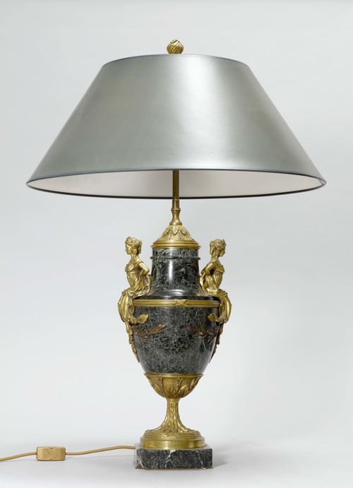 AMPHORA AS A LAMP,Napoléon III, France. Gilt bronze and green marble. Ovoid with ribbed mounts. The handles designed as 2 seated female figures. On a retracted foot. Grey shade. H 88 cm.