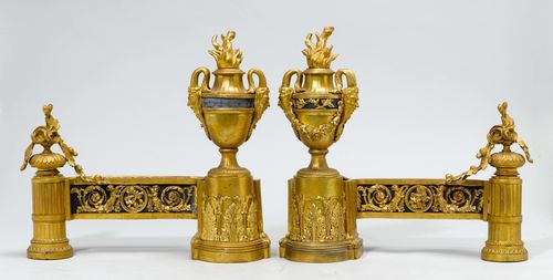 PAIR OF FIREPLACE CHENETS, in the style of Louis XVI., France, 19th century. Gilt bronze. Decorated with faun heads, flowers, etc. H 43, L 45 cm. Provenance: Gut Aabach, Risch am Zugersee.