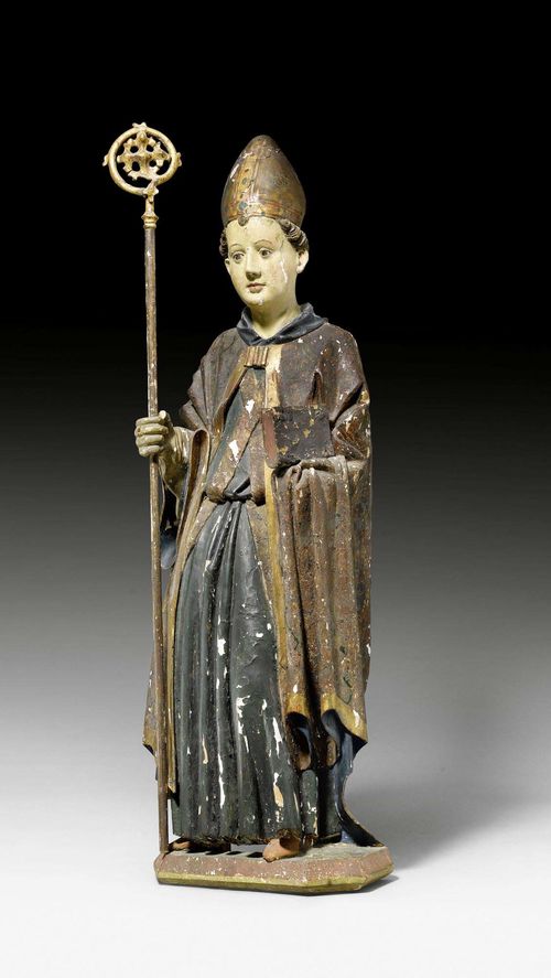 HOLY BISHOP, late Gothic, Southern Alps/Northern Italy, 15th century. Lime, carved, hollowed and painted. The bishop is holding a book in his left hand concealed by the cloak. Right hand, not original. Paint, in part repainted, brittle. Mitre repaired. H 87 cm.