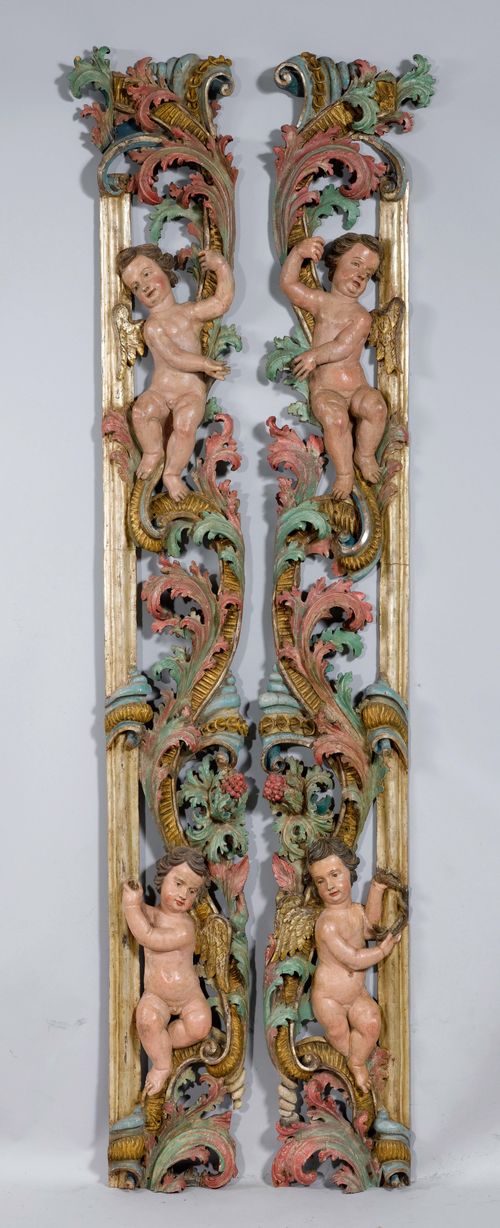 PAIR OF FRIEZES FROM AN ALTAR FRAME,Baroque, Southern Germany, ca. 1700. Wood, carved with angels and leaf volutes and painted. H 265 cm. Provenance: Gut Aabach, Risch am Zugersee.