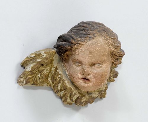 WINGED HEAD OF AN ANGEL,Austria, probably Carinthia, ca. 1700. Wood, carved, verso flattened and painted. Paint, strongly rubbed. H 15 cm.