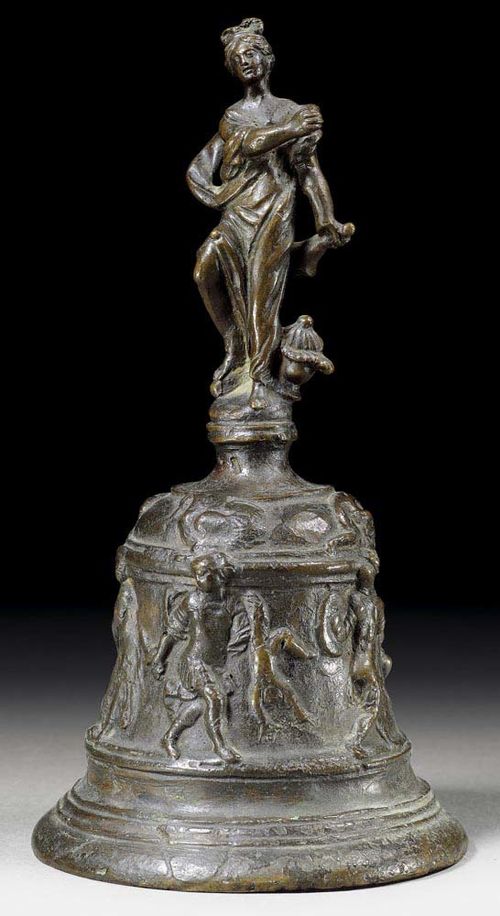 TABLE BELL,late Renaissance, Italy, probably  17th century Burnished bronze. With fine relief decoration depicting king, women, soldiers and fabulous creatures. The handle in the form of a woman with small bell. H 20 cm. Provenance: Swiss private collection.